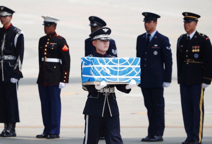 A soldier carries a casket containing the remains of a U.S. soldier who was killed in the Korean War during a ceremony at Osan Air Base in Pyeongtaek